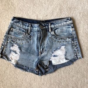 Ripped and studded mid rise jean shorts